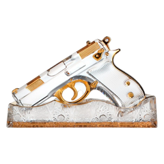 Decorative glass gun with gold accents on a white background