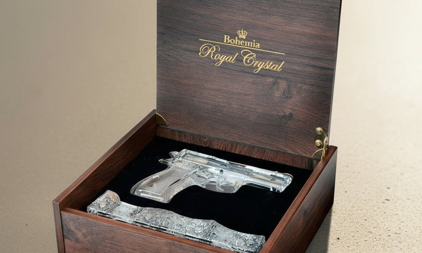 Decorative gun-shaped crystal in a wooden box with 'Royal Crystal' branding.