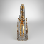 Clear and gold mechanical device on a light gray background